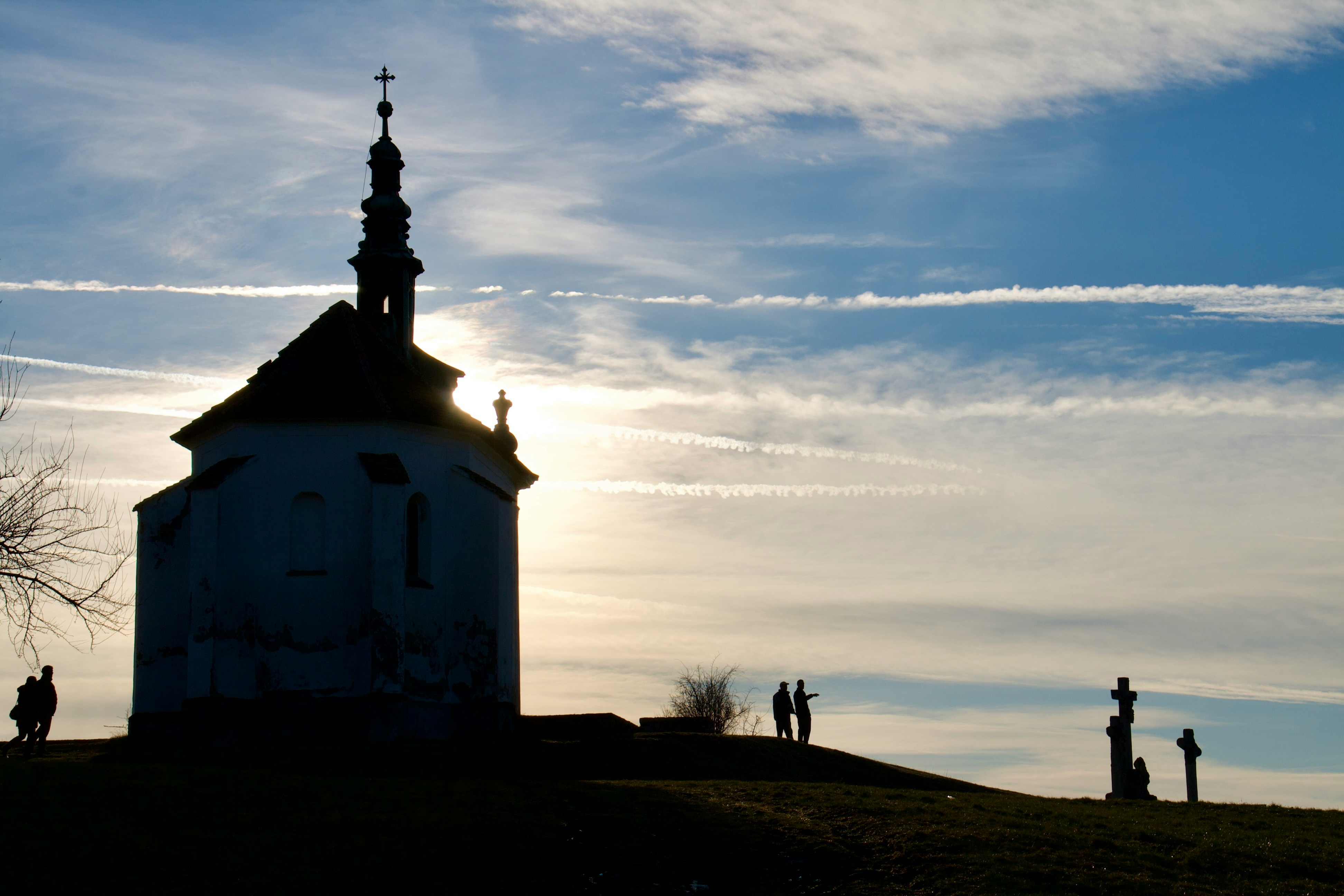 Silhouette of church on top of hill